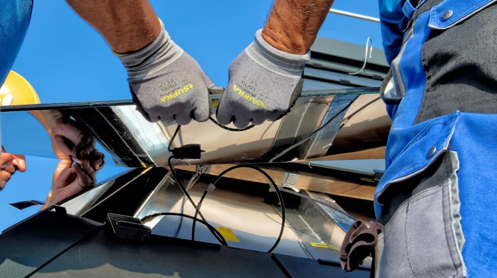 Installer wiring a solar and battery system