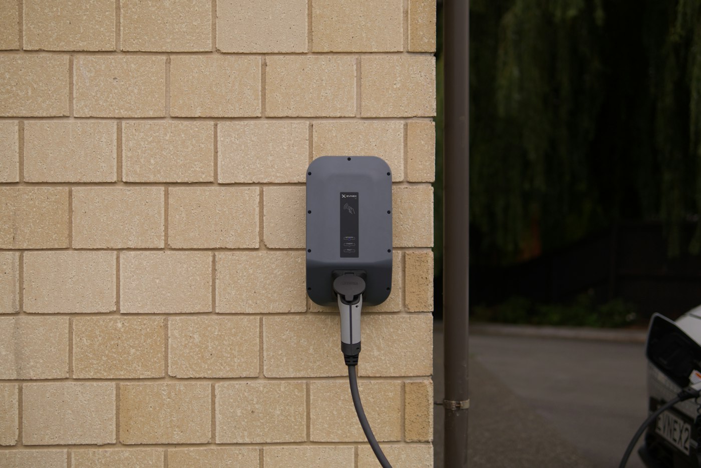 Home EV charger mounted on a garage wall